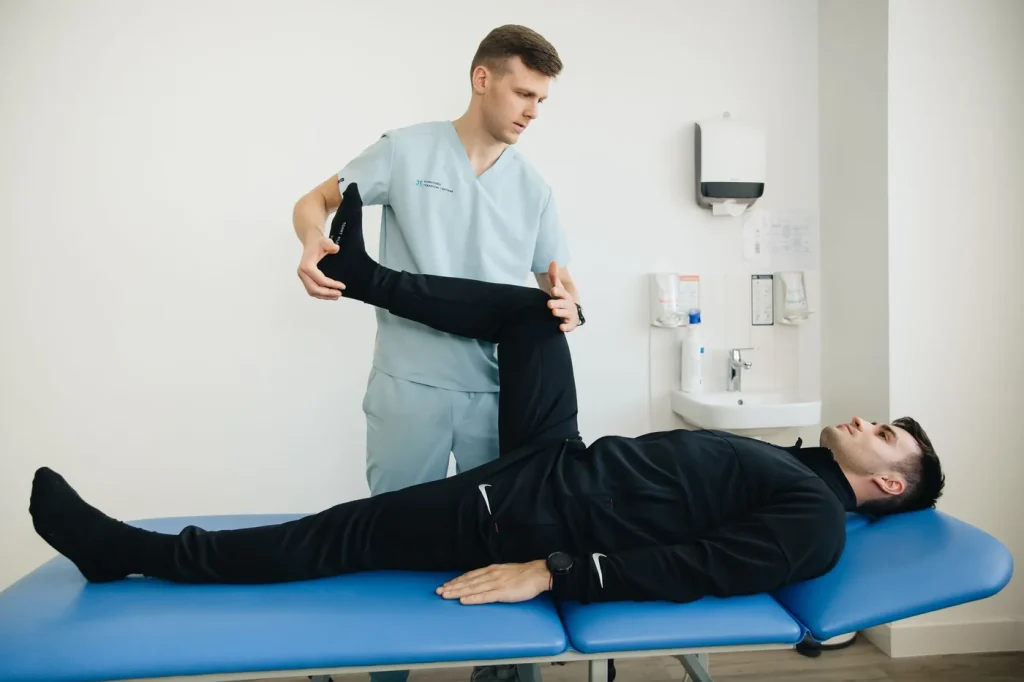 Therapist guiding a patient through a controlled mobility exercise